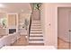 Modern staircase with wooden steps, iron railing, and a view into the living room and fireplace at 116 S Broad St, Waxhaw, NC 28173