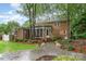 Manicured backyard with screened porch, stone patio, and mature trees at 1209 Alfred St, Charlotte, NC 28211