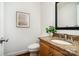 Powder room features granite countertop vanity, wood cabinet, decor, and a toilet at 1209 Alfred St, Charlotte, NC 28211