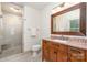 Bathroom features a granite vanity, wood cabinets, and a glass-enclosed shower at 1209 Alfred St, Charlotte, NC 28211