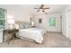 Primary bedroom featuring a ceiling fan, carpet, two windows, and two side tables with lamps at 1209 Alfred St, Charlotte, NC 28211