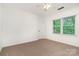 Bedroom with carpet, ceiling fan, and ample sunlight offers a peaceful retreat at 1209 Alfred St, Charlotte, NC 28211