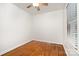 Bright bedroom features hardwood floors, white walls and trim, and window with blinds at 1209 Alfred St, Charlotte, NC 28211