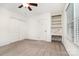 Bedroom features a ceiling fan, carpeted floor, and built-in shelving unit at 1209 Alfred St, Charlotte, NC 28211