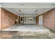 Open carport with brick walls and lighting, providing covered parking and storage at 1209 Alfred St, Charlotte, NC 28211