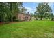Spacious front yard of a brick home, showcasing beautiful landscaping and mature trees at 1209 Alfred St, Charlotte, NC 28211
