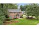 Aerial view of the classic brick home with lush green lawn and mature trees on a large lot at 1209 Alfred St, Charlotte, NC 28211