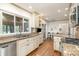 Bright kitchen with granite countertops, stainless steel appliances, white cabinets, and hardwood floors at 1209 Alfred St, Charlotte, NC 28211
