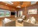 Cozy sunroom with brick wall, ceiling fan, skylights, wicker furniture, and wood paneling at 1209 Alfred St, Charlotte, NC 28211