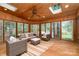 Comfortable sunroom with wicker furniture, ceiling fan, skylights, and wood paneling at 1209 Alfred St, Charlotte, NC 28211