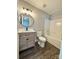 Modern bathroom with wood-look vanity, round mirror, and tub with shower at 1252 Shenandoah Cir, Rock Hill, SC 29730