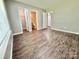 Inviting bedroom showcasing wood-look floors and doorway view to an adjacent bathroom at 1252 Shenandoah Cir, Rock Hill, SC 29730