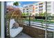Comfortable outdoor balcony area has a unique chair and faces a green view at 130 Rail Crossing Ln # 101, Charlotte, NC 28209