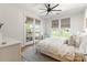 The main bedroom features large windows, a cozy chair, and access to a private balcony at 130 Rail Crossing Ln # 101, Charlotte, NC 28209