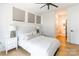 Inviting bedroom features neutral décor, wood floors, and a comfortable bed with bedside tables at 130 Rail Crossing Ln # 101, Charlotte, NC 28209