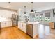 Bright kitchen with an island, stainless steel appliances, and modern lighting at 130 Rail Crossing Ln # 101, Charlotte, NC 28209