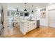 Open-concept with kitchen island, stainless dishwasher, and an adjoining living room at 130 Rail Crossing Ln # 101, Charlotte, NC 28209