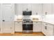A well lit kitchen with white cabinetry, stainless steel appliances, and white backsplash at 130 Rail Crossing Ln # 101, Charlotte, NC 28209