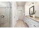 Bathroom with granite counters, double sinks, tiled shower, and large walk-in closet at 14210 Asbury Park Rd, Huntersville, NC 28078