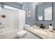 Cozy bathroom featuring granite countertops, a framed mirror, and a shower-tub combination, designed for relaxation and comfort at 14210 Asbury Park Rd, Huntersville, NC 28078