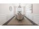 Elegant dining room with a modern chandelier, a stylish table setting, and wainscoting, creating a sophisticated ambiance at 14210 Asbury Park Rd, Huntersville, NC 28078
