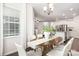 Bright dining room with a view to the kitchen and a modern chandelier at 14210 Asbury Park Rd, Huntersville, NC 28078