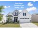 Charming two-story home boasts a landscaped front yard and a spacious two-car garage at 14210 Asbury Park Rd, Huntersville, NC 28078