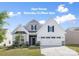 Charming two-story home with a white facade, black shutters and a well-manicured front lawn at 14210 Asbury Park Rd, Huntersville, NC 28078