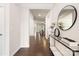 Elegant foyer with hardwood floors, modern console table, decorative mirror, and open entryway, offering a welcoming ambiance at 14210 Asbury Park Rd, Huntersville, NC 28078