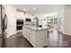 Open kitchen and dining area with hardwood floors and stainless steel appliances at 14210 Asbury Park Rd, Huntersville, NC 28078