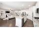 Modern open concept kitchen with granite countertops, stainless steel appliances, and a seamless view into the living area at 14210 Asbury Park Rd, Huntersville, NC 28078