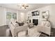 Spacious living room with a ceiling fan, fireplace, and plenty of natural light at 14210 Asbury Park Rd, Huntersville, NC 28078