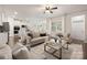 Living room with views to the kitchen and dining, fireplace, fan, and plenty of light at 14210 Asbury Park Rd, Huntersville, NC 28078