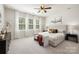 Serene main bedroom with large windows, ceiling fan, and a decorative bench at 14210 Asbury Park Rd, Huntersville, NC 28078