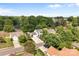 Aerial view of a well-manicured property nestled among mature trees in a quiet neighborhood at 150 Pleasant Grove Ln, Mooresville, NC 28115
