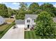 An aerial view of a two-story home with a driveway, manicured lawn, and tree lined backyard at 150 Pleasant Grove Ln, Mooresville, NC 28115