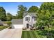 Overhead view of a two-story home showcasing a manicured lawn, attached garage, and mature trees at 150 Pleasant Grove Ln, Mooresville, NC 28115