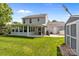 Spacious backyard with an enclosed patio, storage shed, and well-maintained lawn at 150 Pleasant Grove Ln, Mooresville, NC 28115
