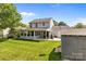 Grassy backyard featuring a manicured lawn, shed, and an outdoor kitchen area at 150 Pleasant Grove Ln, Mooresville, NC 28115