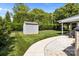 Well-maintained backyard with a storage shed, manicured lawn, and neatly landscaped garden at 150 Pleasant Grove Ln, Mooresville, NC 28115