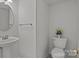 Clean half bathroom with a modern vessel sink, chrome towel bar, and toilet with a decorative flower vase at 150 Pleasant Grove Ln, Mooresville, NC 28115