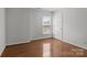 Bedroom with hardwood floors and window with white trim at 150 Pleasant Grove Ln, Mooresville, NC 28115