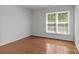 Bright bedroom featuring hardwood floors and a window providing natural light at 150 Pleasant Grove Ln, Mooresville, NC 28115