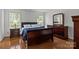 Comfortable bedroom featuring wood floors and neutral color scheme at 150 Pleasant Grove Ln, Mooresville, NC 28115