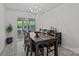 Dining room with dark wood table and chairs, chandelier, and sliding glass doors to outside at 150 Pleasant Grove Ln, Mooresville, NC 28115