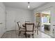 Cozy dining area with a round table, four chairs, and sliding glass door access to outdoor space at 150 Pleasant Grove Ln, Mooresville, NC 28115