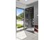 Welcoming entryway with an open black front door and natural light highlighting tiled floors and staircase at 150 Pleasant Grove Ln, Mooresville, NC 28115