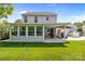 Home exterior featuring an enclosed sunroom and covered patio overlooking a lush lawn at 150 Pleasant Grove Ln, Mooresville, NC 28115