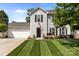 Charming two-story home featuring a well-manicured lawn, an attached two-car garage, and lovely curb appeal at 150 Pleasant Grove Ln, Mooresville, NC 28115