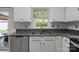 Close up of kitchen sink and countertop with stainless steel dishwasher and stainless steel sink at 150 Pleasant Grove Ln, Mooresville, NC 28115